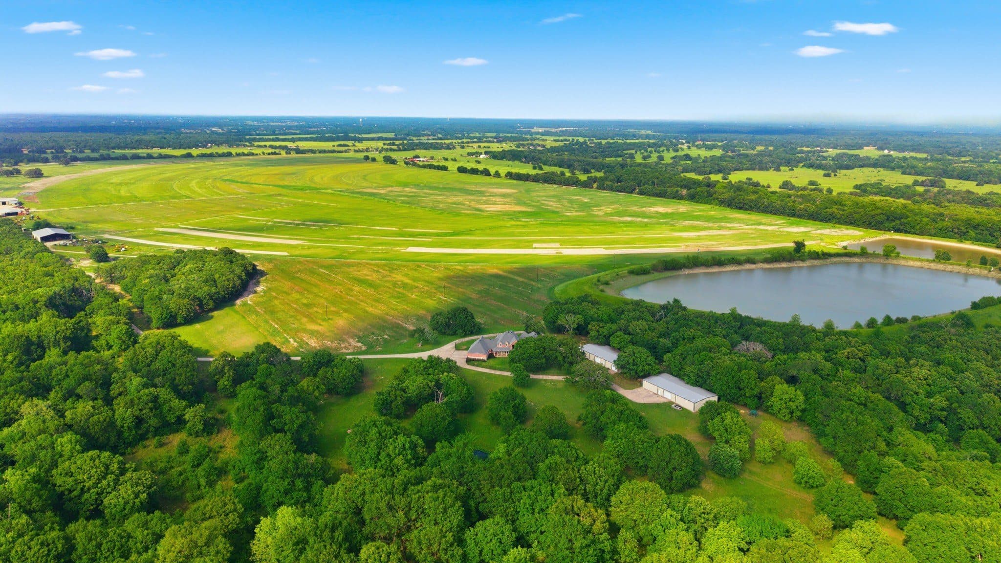 Aerial composition of grass fields and tree lines at 752 CR 3103