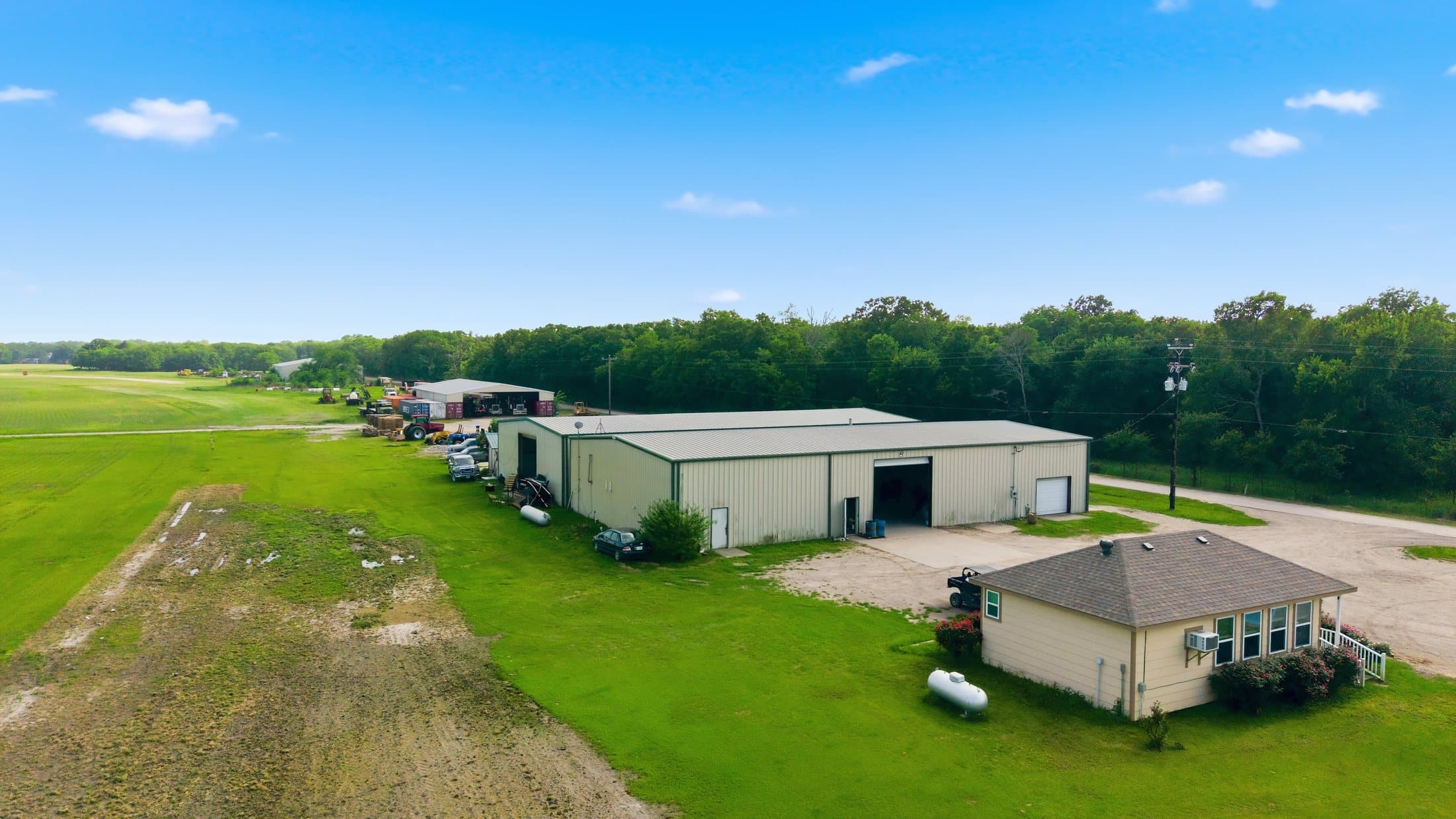 Summer aerial of the equipment yard and workshop area at the primary site