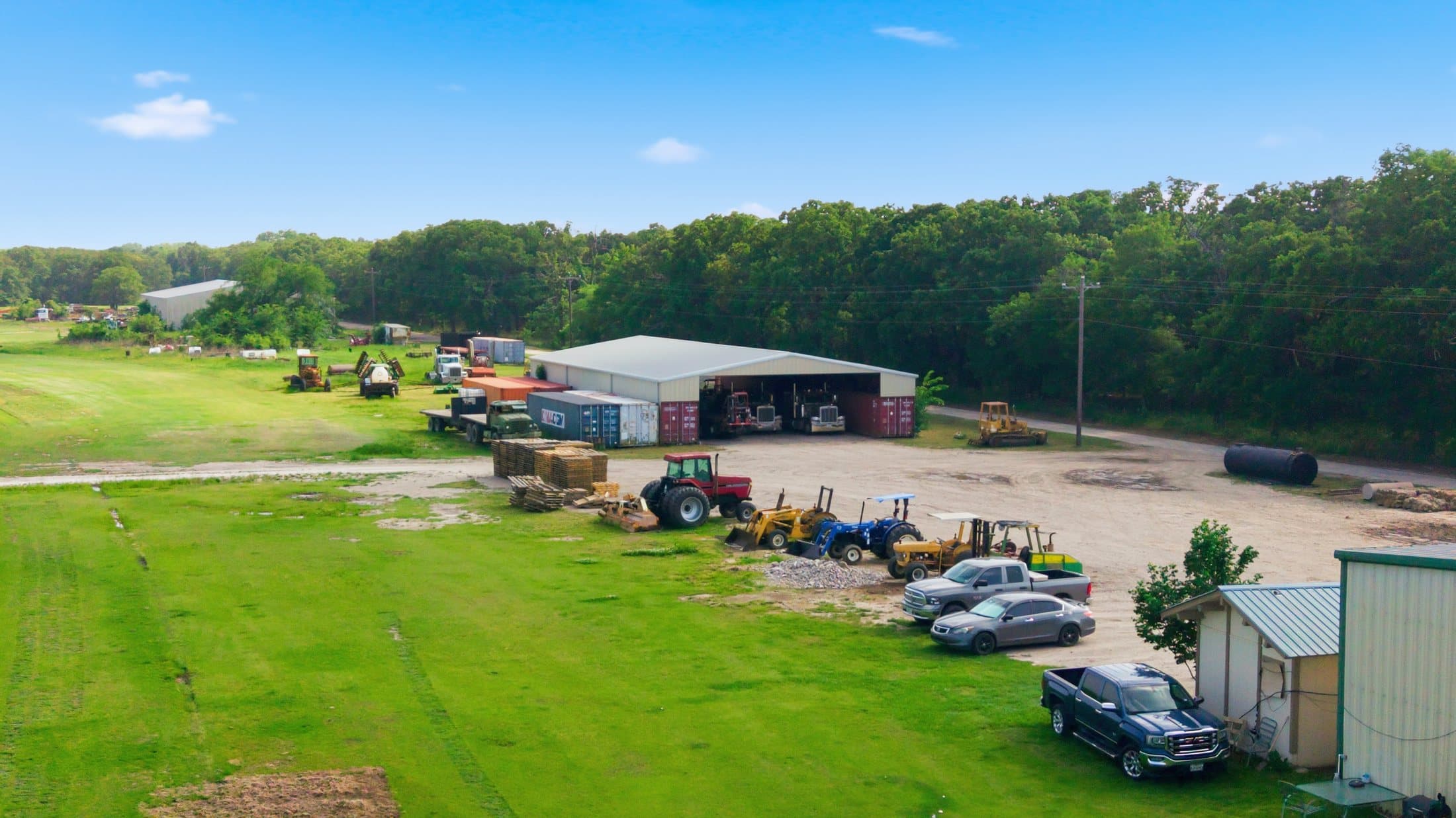 Summer aerial of the operations yard with staged tractors, trucks and equipment