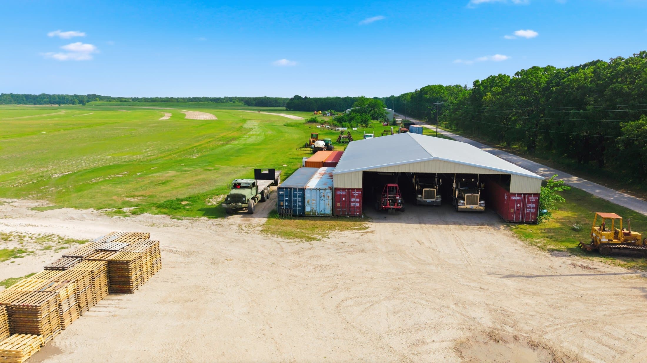 Summer aerial of the truck shed with Peterbilt fleet and shipping container storage
